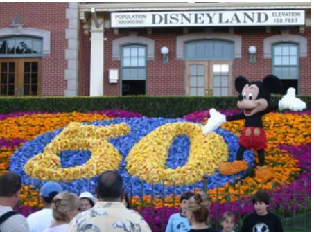 Disneyland Resort entrance with Mickey Mouse and a floral 60 display