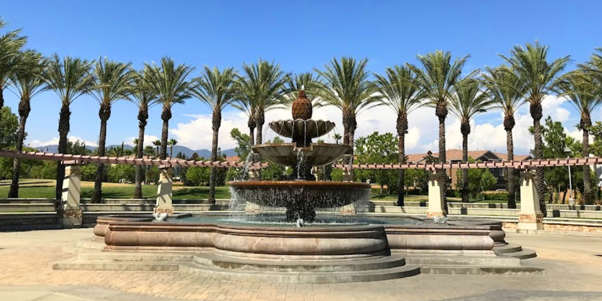 Fontana park fountain framed by palm trees